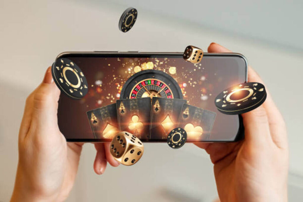 creative background online casino in a mans hand a smartphone with playing cards roulette and